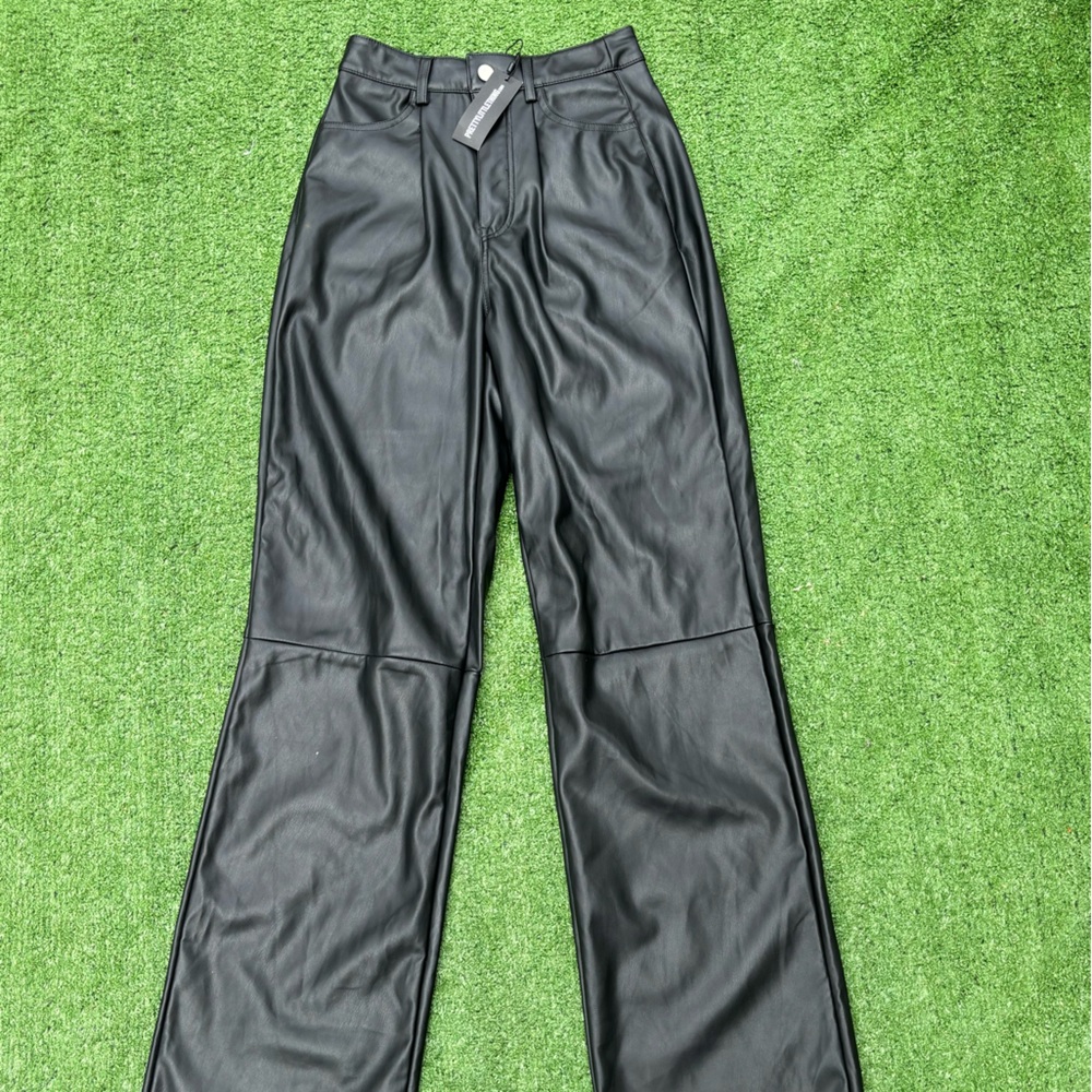 Black faux leather least detail wide leg trousers.